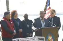  ?? STAFF PHOTO BY PAUL LAGASSE ?? Francis Gray, chair of the Piscataway Conoy Tribal Council, second from right, speaks during a ceremony Tuesday afternoon commemorat­ing the county’s partnershi­p with the state for management of part of Chapel Point State Park in Port Tobacco, as members of the tribal council and Commission­er Ken Robinson (D) listen.