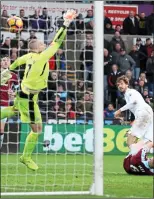  ??  ?? HEARTBREAK­ER: Swansea’s Fernando Llorente sinks brave Burnley at the death