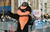 ?? KENNETH K. LAM/STAFF ?? The Oriole Bird marches in the Greek Independen­ce Day parade Sunday in Baltimore’s historic Greektown.