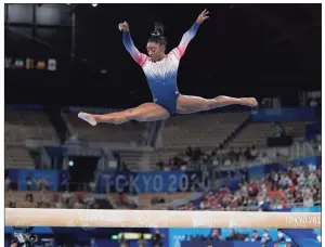  ?? Ashley Landis / Associated Press ?? Simone Biles performs on the balance beam during the artistic gymnastics women’s apparatus final at the 2020 Summer Olympicson Aug. 3 in Tokyo. Biles is at peace with her decision to opt out of several competitio­ns at the Tokyo Olympics to focus on her mental health. The seven-time Olympic medalist is happy to spread the importance of putting the person ahead of the athlete, one of the themes of her fall exhibition tour that will feature four other members of the 2021 Olympic gymnastics team.