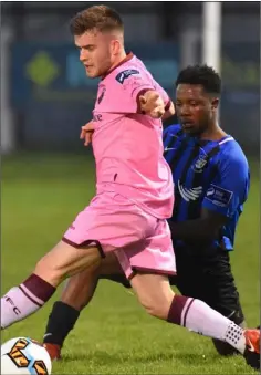  ??  ?? Liam McCartan in action against George Mukete of Athlone Town .