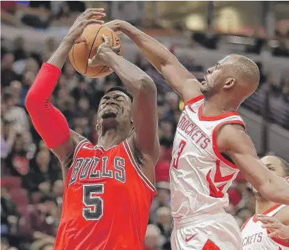  ??  ?? Rockets guard Chris Paul blocks Bulls forward Bobby Portis’ shot in the second half. Portis had a team- high 22 points.