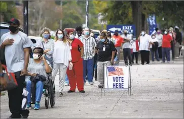  ?? Michael Holahan Associated Press ?? MORE THAN 100 business leaders joined an hourlong Zoom call to discuss ways to address efforts to restrict voting in Georgia, Texas and other states. Above, people line up for early voting in Augusta, Ga., in October.