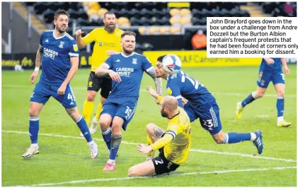  ??  ?? John Brayford goes down in the box under a challenge from Andre Dozzell but the Burton Albion captain’s frequent protests that he had been fouled at corners only earned him a booking for dissent.