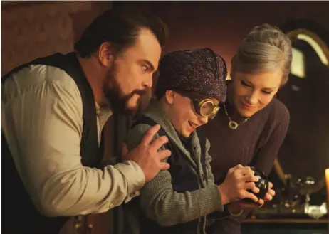  ?? | UNIVERSAL PICTURES ?? A warlock (Jack Black, left) and a witch (Cate Blanchett) teach their ways to young Lewis (Owen Vaccaro) in “The House With a Clock in Its Walls,” based on a popular young adult book by John Bellairs.
