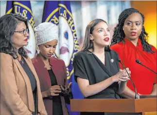  ?? J. Scott Applewhite The Associated Press ?? Rep. Alexandria Ocasio-cortez, D-N.Y., speaks at a news conference Monday while surrounded by Democratic House colleagues Rashida Tlaib and Ilhan Omar, left, and Ayanna Pressley. The news conference was in response to tweets in which President Donald Trump erroneousl­y insinuated that the four are immigrants and said they should go back to their own countries.