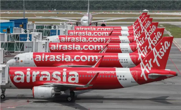  ?? Reuters ?? AirAsia planes at Kuala Lumpur Internatio­nal Airport 2. The Covid-19 pandemic has brought travel to a halt, hitting airlines around the world hard