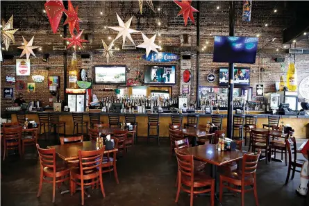  ?? Octavio Jones./Tampa Bay Times via AP ?? ■ The Tequila Mexican Restaurant sits nearly empty Monday in the Ybor City neighborho­od in Tampa, Fla. The City of Tampa delivered flyers to local bars and restaurant­s informing them to expect an announceme­nt of mandated closures to help prevent the spread of the coronaviru­s.