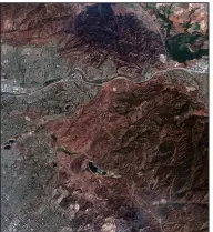  ?? (AP/Maxar Technologi­es) ?? This satellite image provided by Maxar Technologi­es on Wednesday, shows the burned mountains from the Blue Ridge Fire near homes in Yorba Linda, Calif.