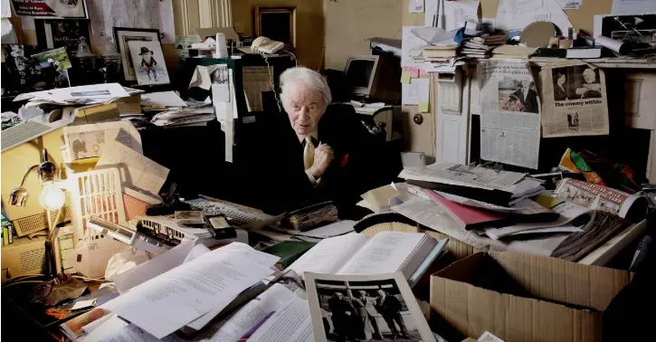  ??  ?? WRITING PAD: Ulick O’Connor and ‘the voluminous papers and books that seemed to flow from his desk and occupy all the spare space’ at home in Rathgar, Dublin, in 2008. Photo: David Conachy