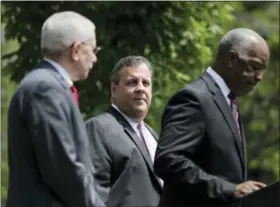  ?? SETH WENIG — THE ASSOCIATED PRESS ?? New Jersey Gov. Chris Christie, center, waits to speak during a news conference in Trenton, N.J., on Tuesday. The Supreme Court agreed Tuesday to take up New Jersey’s bid to allow sports betting at its casinos and racetracks, a case that could lead...