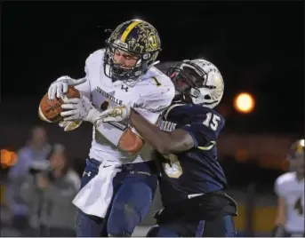  ?? PETE BANNAN — DIGITAL FIRST MEDIA ?? Unionville receiver Joe Zubillaga hauls in a first down pass in the first quarter as Sun Valley’s Alex Gorgone defends.