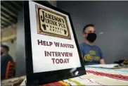  ?? ASSOCIATED PRESS FILE PHOTO ?? A hiring sign is placed at a booth for Jameson’s Irish Pub during a job fair, Sept. 22, in the West Hollywood section of Los Angeles.