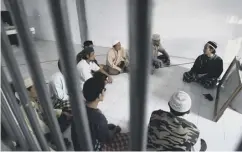  ??  ?? Inmates attend a religious class in an Indonesian prison
