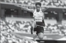  ?? ADAM PRETTY/GETTY IMAGES ?? Hossain Rasouli of Team Afghanista­n competes in the Men's Long Jump - T47 Final during the Paralympic Games on Aug. 31 in Tokyo.