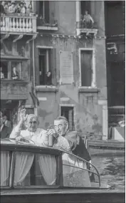  ?? ?? Pope Paul VI, left, waves to the crowd while Venice Patriarch Cardinal Albino Luciani points to a landmark as they ride in a motorboat in Venice, northern Italy.