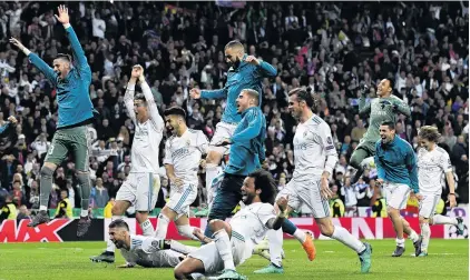  ?? PHOTO: GETTY IMAGES ?? Real delight . . . Real Madrid’s players celebrate after drawing 22 in the second leg of the Champions League semifinal with Bayern Munich in Madrid yesterday to reach the final 43 on aggregate.