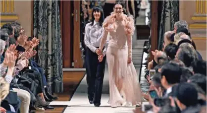  ??  ?? This file photo shows French fashion designer for Lanvin, Bouchra Jarrar, left, acknowledg­ing the audience at the end of her women's Fall-Winter 20172018 ready-to-wear collection fashion show in Paris.