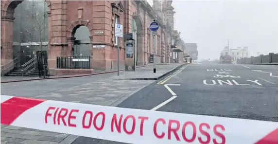  ?? Matthew Vincent ?? > Fire service tape at the scene close to Nottingham railway station