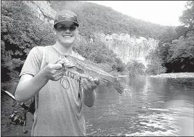  ?? Arkansas Democrat-Gazette/BRYAN HENDRICKS ?? admires his last fish of the day on the Buffalo River, a 16-inch beauty that struck downstream from the campground at Steel Creek.