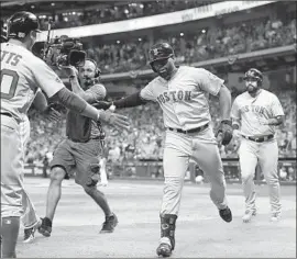  ?? Frank Franklin II Associated Press ?? BOSTON’S Jackie Bradley Jr. is greeted after his eighth-inning grand slam gave the Red Sox an 8-2 lead and sent the Houston fans heading for the exits.