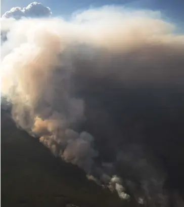  ??  ?? A fire burns near High Level, Alta., in May 2019, forcing thousands from their homes