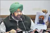  ?? HT PHOTO ?? Punjab CM Captain Amarinder Singh showing KLF operative Bikramjit Singh’s picture to the media in Chandigarh; and (below) the other accused, Avtar Singh, who is at large.