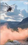  ??  ?? Helicopter crew arrives to rescue a Glencoe paraglider after spotting distress flare