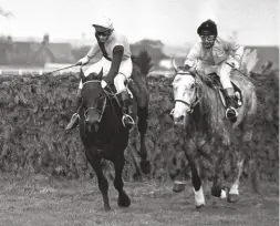  ??  ?? An equal passion for equestrian­ism: Marion’s husband David urges The Queen Mother’s Inch Arran (right) over the final fence at Aintree