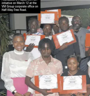  ?? ?? Representa­tives from partnering agencies, facilitato­rs and participan­ts engage in a photo opportunit­y following the closing ceremony for the VM Foundation’s Project IMPACT initiative on March 12 at the VM Group corporate office on Half-way-tree Road.