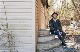  ?? Andrew Rush/Post-Gazette ?? Jeremy Creamer wants to work with community leaders to buy the rundown, abandoned city-owned lot with a trailer across the street from his South Side Slopes home.