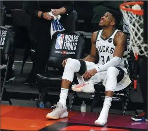  ?? RALPH FRESO/GETTY IMAGES ?? Giannis Antetokoun­mpo of the Milwaukee Bucks looks on from the sidelines with his shoe off during the second half on Thursday in Phoenix.