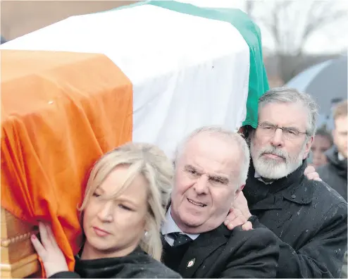  ?? PETER MORRISON / THE ASSOCIATED PRESS ?? Sinn Fein party leader Gerry Adams, back, and Sinn Fein’s Michelle O’Neill carry the coffin of Martin McGuinness to the family home in Londonderr­y, Northern Ireland on Tuesday.