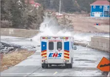  ?? CP PHOTO ?? An EHS truck drives as sea water crashes over the road in Western Head. After another weekend of storm surges battering Nova Scotia’s south shore, there are rising concerns from some municipal politician­s and citizens about the need for help adapting...