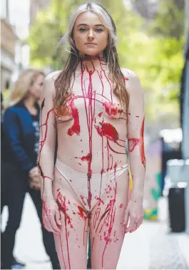  ?? ?? A PETA protester in Sydney's Pitt Street Mall dressed as a human meat tray. Picture: David Swift