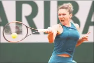  ?? Matthew Stockman / Getty Images ?? Simona Halep plays a forehand during a quarterfin­als match against Angelique Kerber on Tuesday at the French Open.