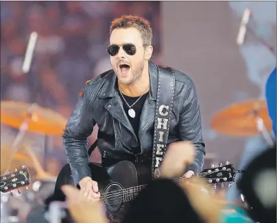  ??  ?? Country music singer Eric Church performs at halftime during an NFL football game between the Washington Redskins and Dallas Cowboys in Arlington, Texas. Church is one of many musicians using new technology to reach the smartphone generation of music fans.