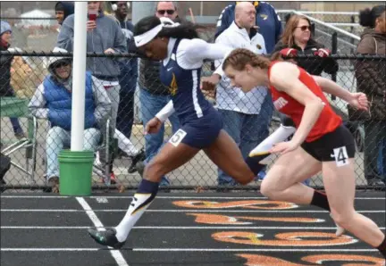  ?? PAUL DICICCO — THE NEWS-HERALD ?? Euclid’s Caisja Chandler, left, edges Mentor’s Paige Floriea to win the 100 meters on April 21 during the Ranger Relays at North.