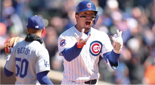  ?? MICHAEL REAVES/GETTY IMAGES ?? Seiya Suzuki celebrates after hitting a two-run double in the second inning. The right fielder sports a .345/394/.621 slash line to start the season.