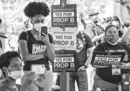  ?? Matthew Busch / Contributo­r ?? People attend a rally at Pittman-Sullivan Park last month to support Propositio­n B, which would strip the police union of its power to bargain for a contract.