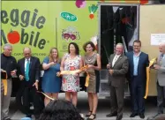  ?? PHOTOS BY MELISSA SCHUMAN — MEDIA NEWS GROUP ?? The ceremonial ribbon is cut for the new Veggie Mobile by CEO Amy Klein and attending dignitarie­s.