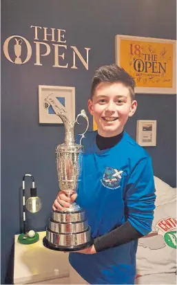  ??  ?? Joshua Marshall, 11, was delighted when he came home to find the Claret Jug in his room.