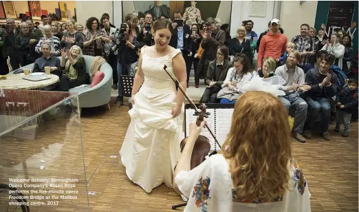  ??  ?? Welcome delivery: Birmingham Opera Company’s Alison Rose performs the five-minute opera Freedom Bridge at the Mailbox shopping centre, 2017