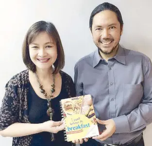  ??  ?? Taste makers: Aurora Alipao, Nestle corporate communicat­ions VP and consumer engagement services head, with Paolo Mercado, communicat­ion and marketing services director, hold a copy of the hot book, served fresh from the Nestle kitchen