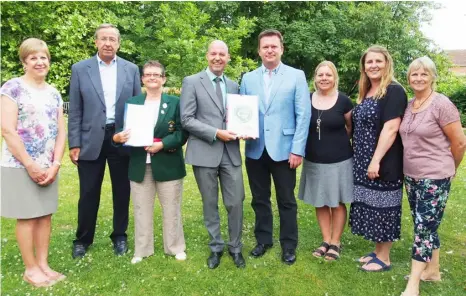  ?? Picture: Gemma Davidson ?? Graham Ebers from Wokingham Borough Council receives the petitions from Finchampst­ead residents