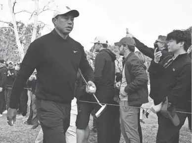  ?? GARY A. VASQUEZ/USA TODAY SPORTS ?? Tiger Woods is greeted by spectators on Friday during the Genesis Invitation­al.