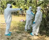  ?? CAMBODIA MINISTRY OF HEALTH ?? Health workers spray disinfecta­nt Friday in the Prey Veng province of Cambodia. A girl from the province died after contractin­g the bird flu virus.