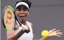  ?? TIM IRELAND/ASSOCIATED PRESS ?? Venus Williams returns a shot during her 7-6, 6-4 victory over Elise Mertens in the first round at Wimbledon. The 10th-seeded Williams is being sued over a fatal car wreck.