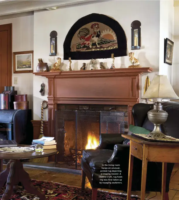  ??  ?? In the living room hangs an unusual, arched rug depicting a crowing rooster. A country craft, rug hooking was first taken up by voyaging seafarers.