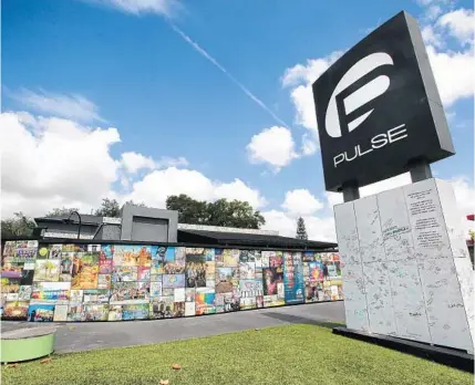  ?? JOE BURBANK/ORLANDO SENTINEL ?? Photos and keepsakes adorn the Pulse Interim Memorial located at the Pulse nightclub site south of downtown Orlando in 2019.